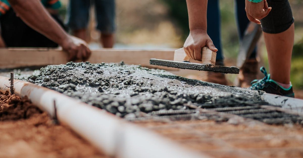 A group of people are working on a sidewalk.