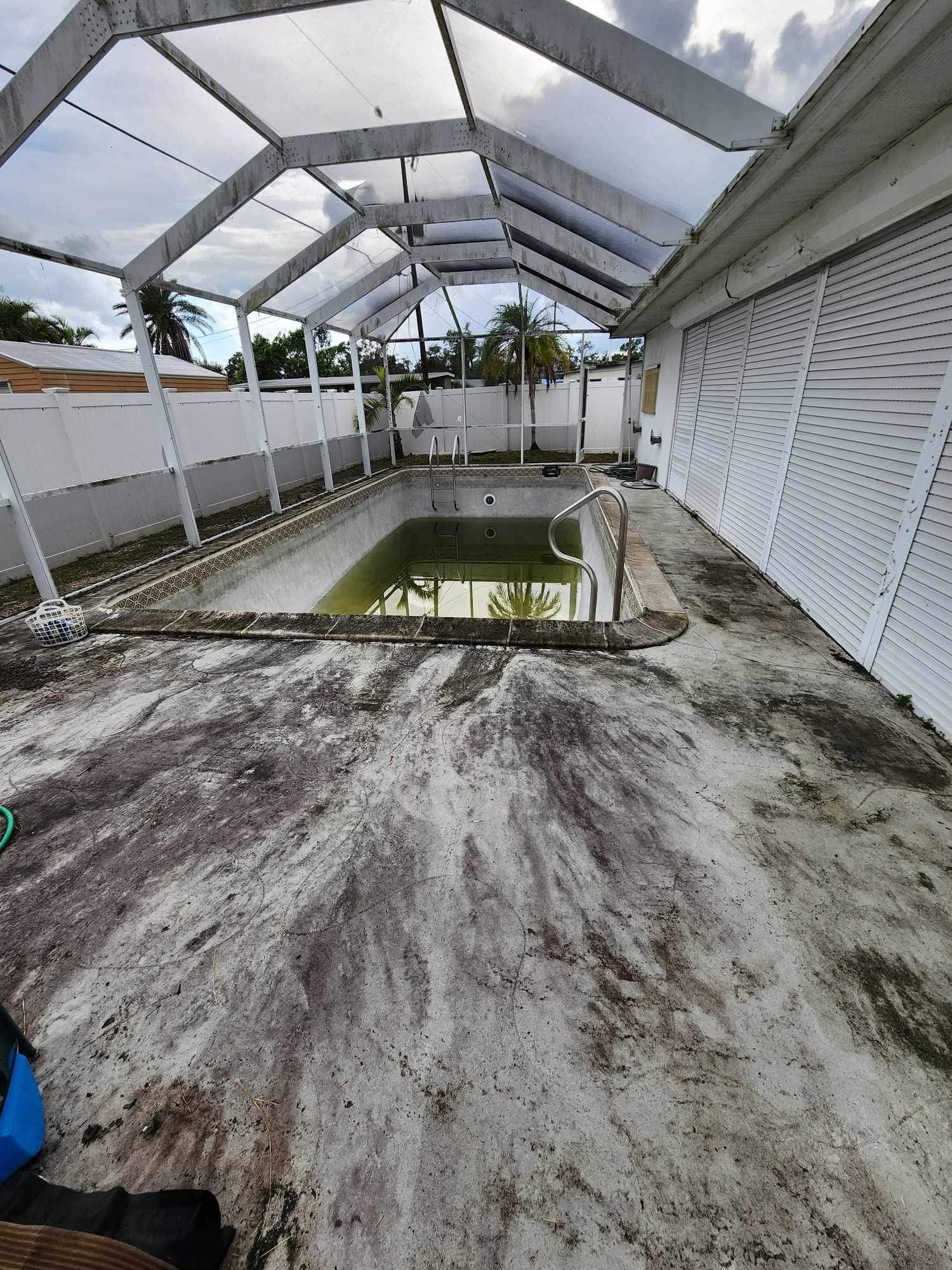 There is a swimming pool in the backyard of a house.