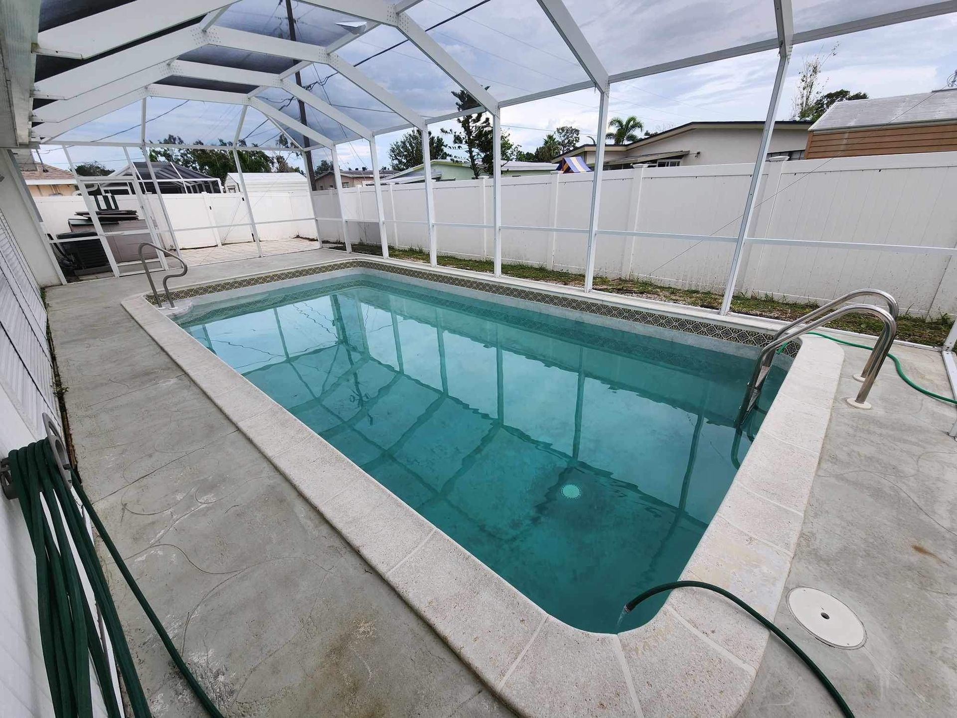 A large swimming pool with a hose attached to it