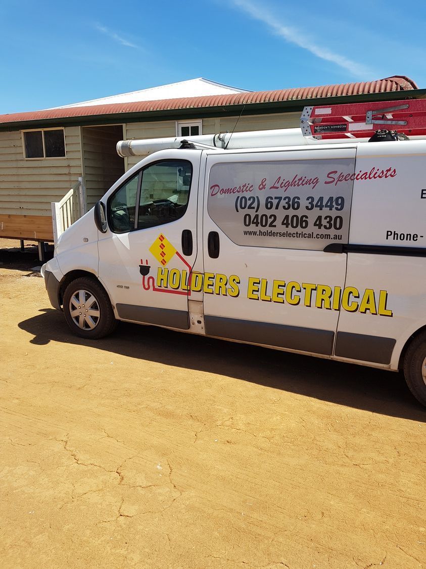 White Electrical Service Van Parked in Front of a House on a Sunny Day  — Holders Electrical In Tenterfield, NSW 