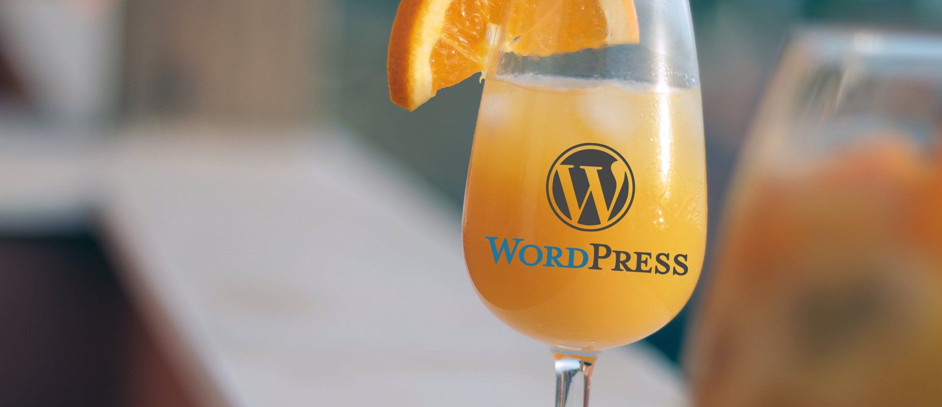WordPress logo showing on a glass of juice