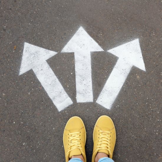 a person standing in front of three arrows painted on the ground