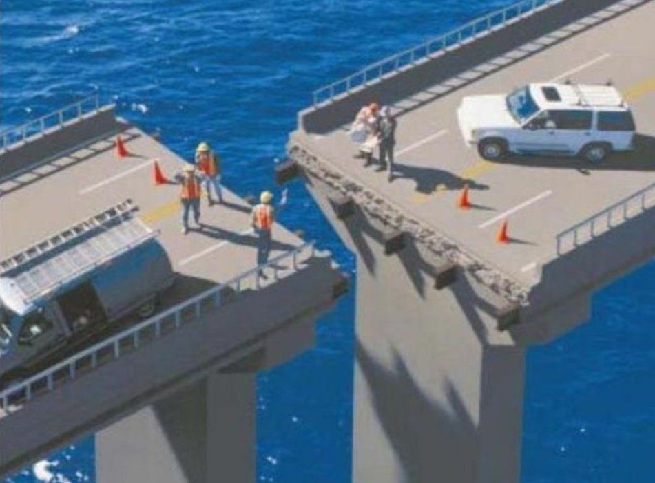 A white suv is driving on a bridge over the ocean