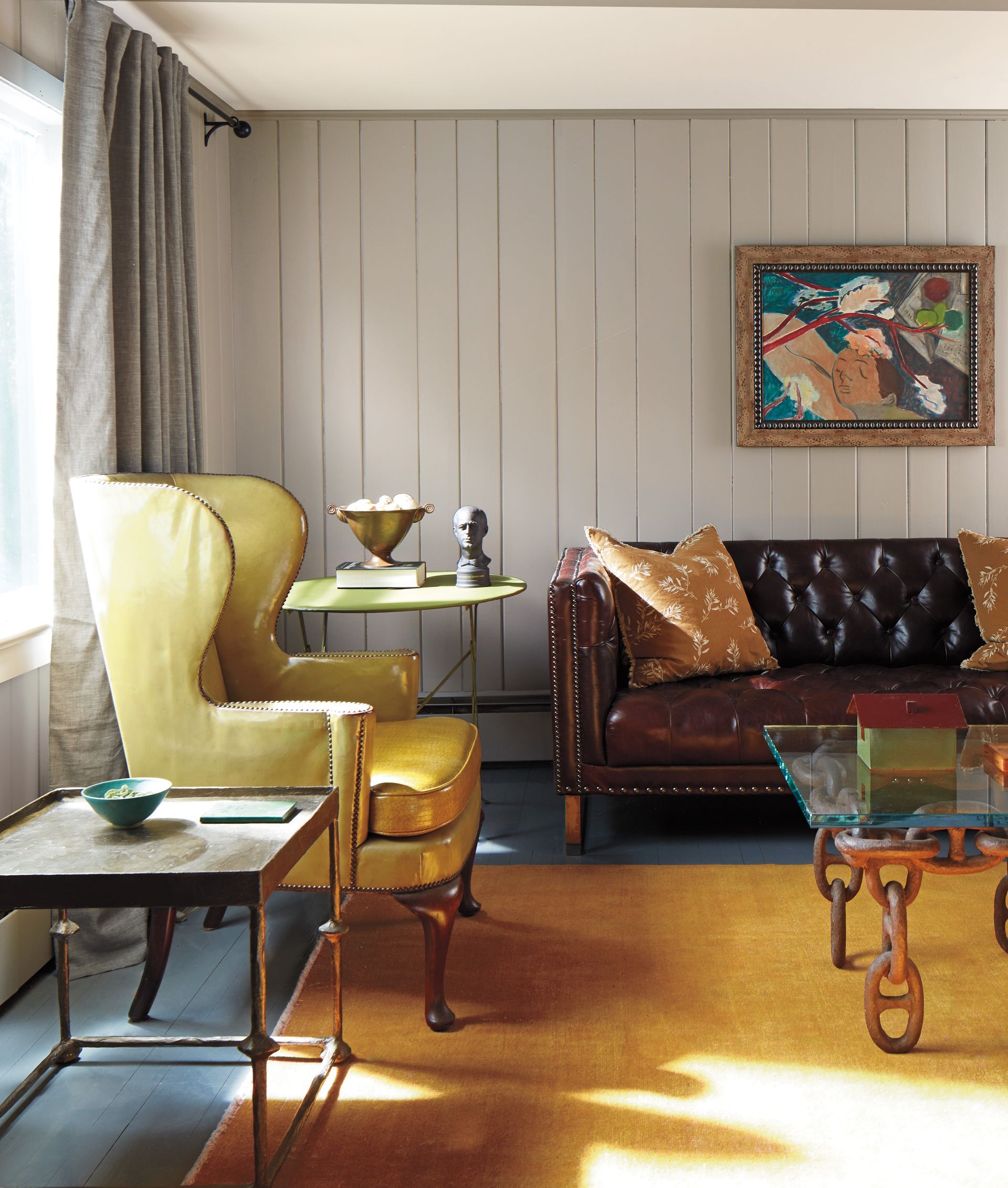 A living room with a couch a chair and a table