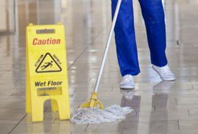 a cleaner polishing a tiled floor