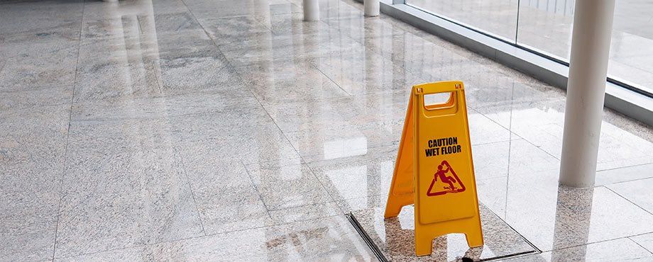a 'wet floor' caution sign on an office floor 