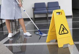 a cleaner polishing a floor 