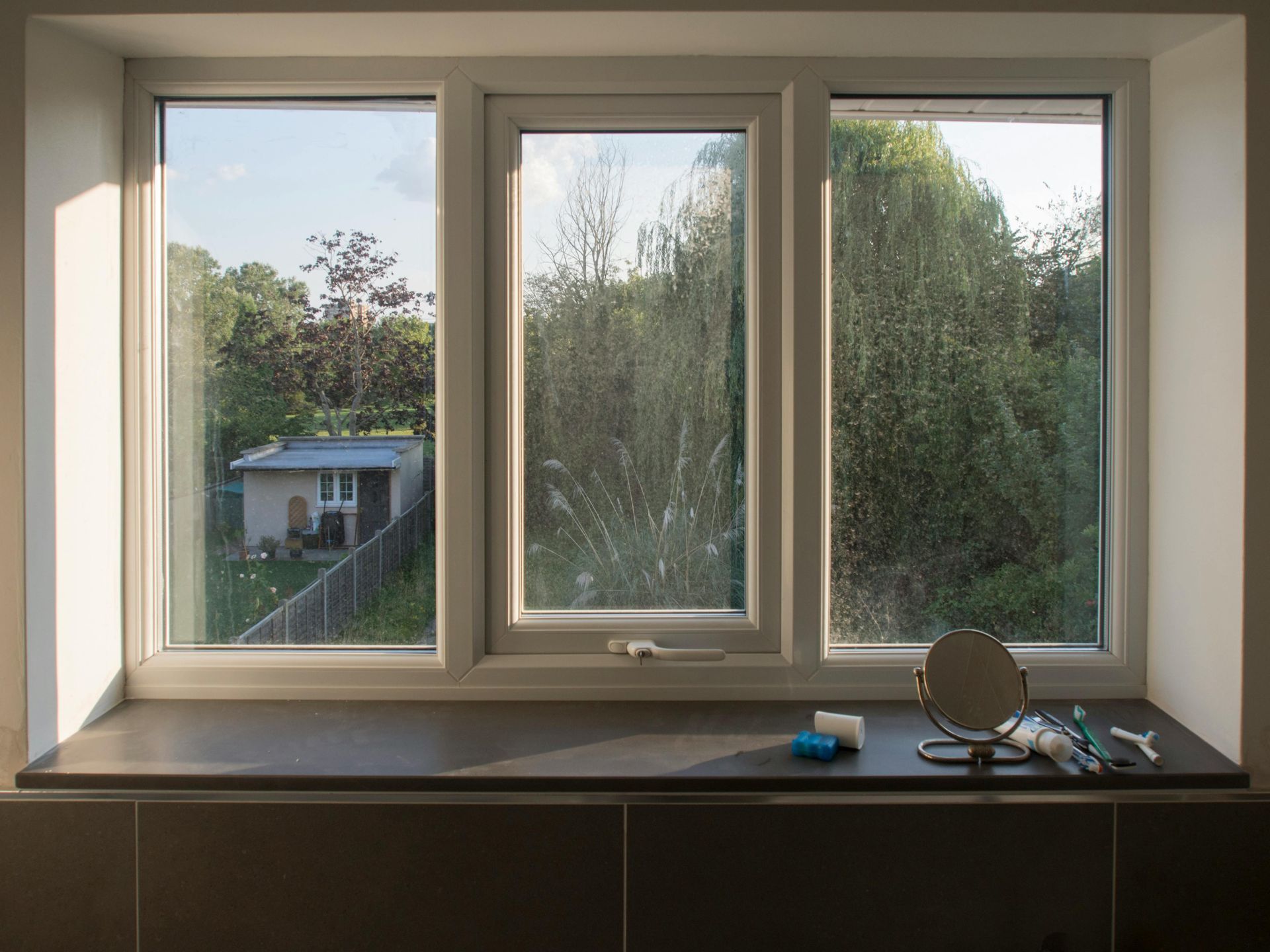 A person is applying tinted glass to a car window