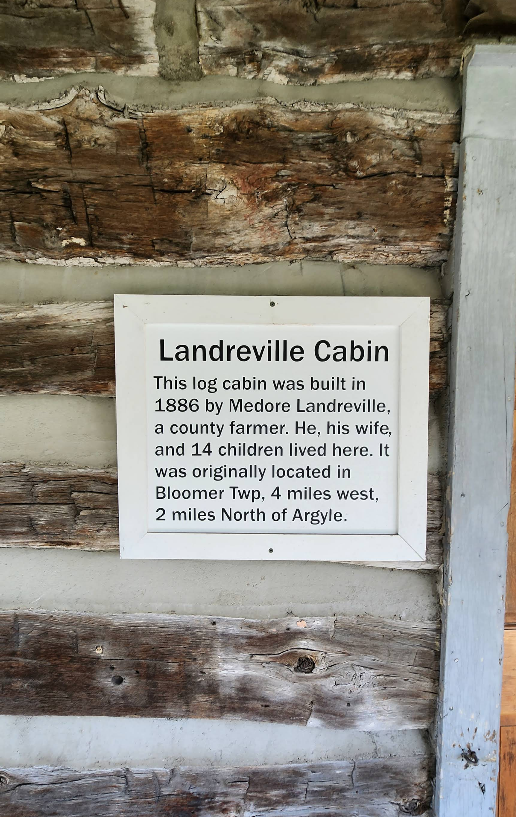 Sign on a log cabin: