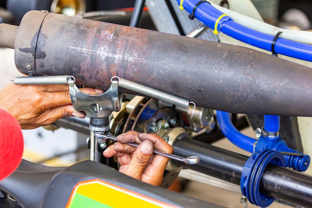 A Person Is Working On A UTV With A Wrench — Somerset Ride-On Mower Repairs In Kilcoy, QLD