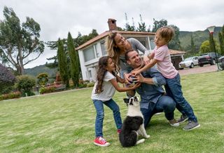 family in yard with dog