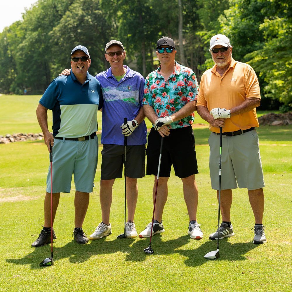 Men Holding Golf Clubs — Lake Wylie, SC — Mayday Project