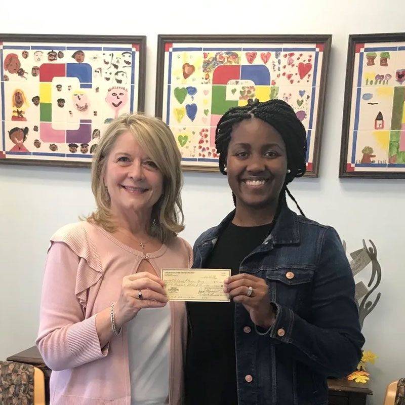 Two Women Holding a Check — Lake Wylie, SC — Mayday Project