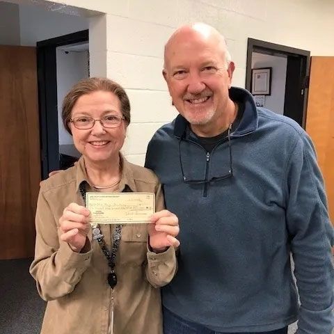 Woman Holding a Check — Lake Wylie, SC — Mayday Project