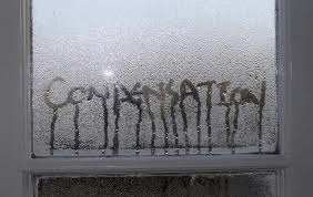The word conversation is written on a window with condensation on the pane.