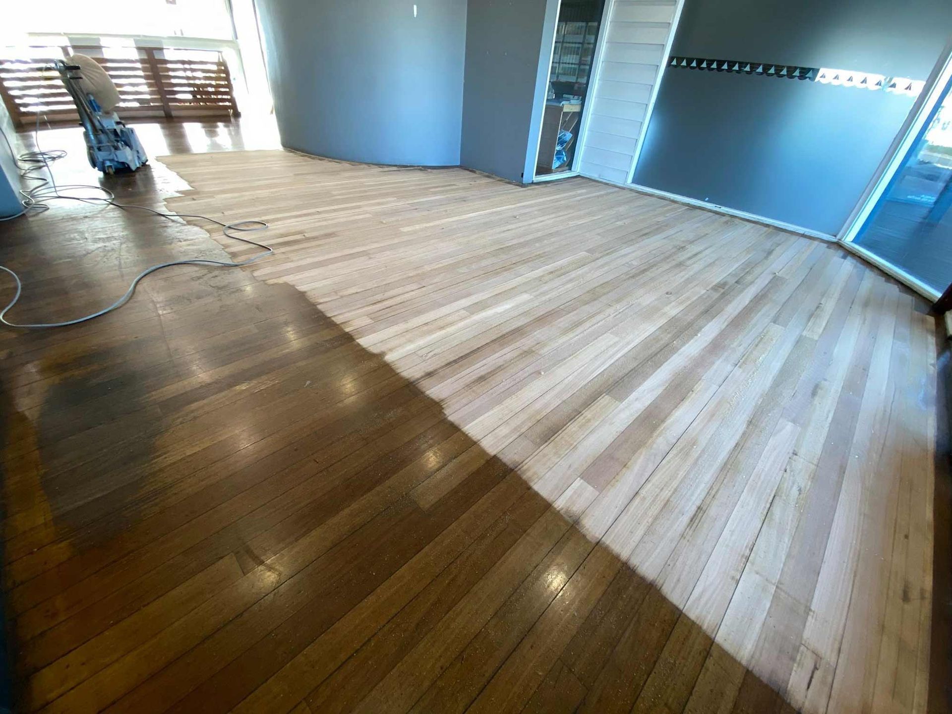 A Wooden Floor Is Being Sanded In A Room — Brett Hall Floorsanding in Taree, NSW
