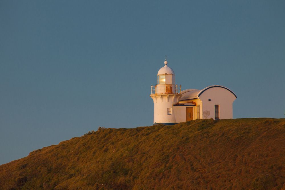 A Lighthouse Is Sitting On Top Of A Hill — Brett Hall Floorsanding in Port Macquarie, NSW