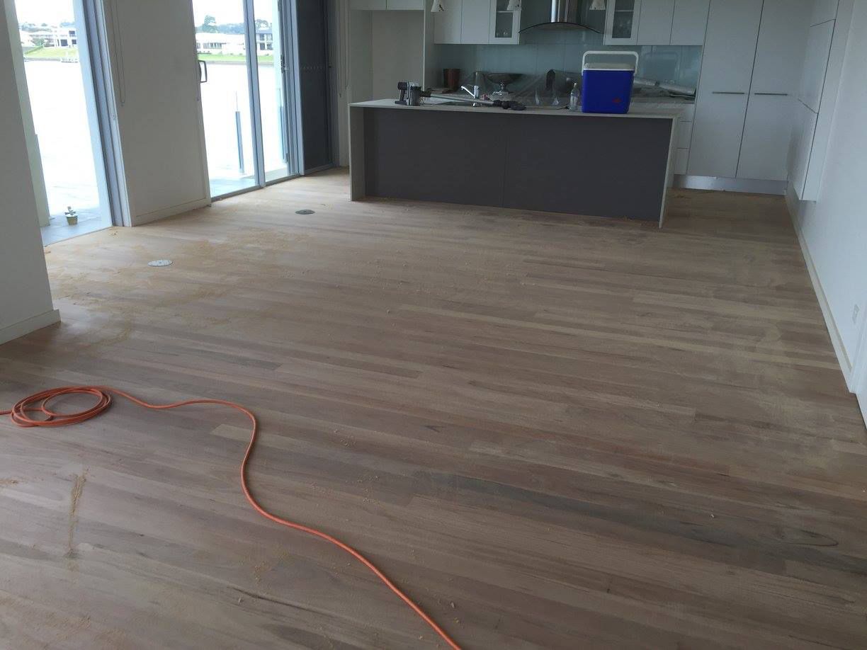 A Kitchen With A Wooden Floor And A Cooler On The Counter — Brett Hall Floorsanding in Taree, NSW