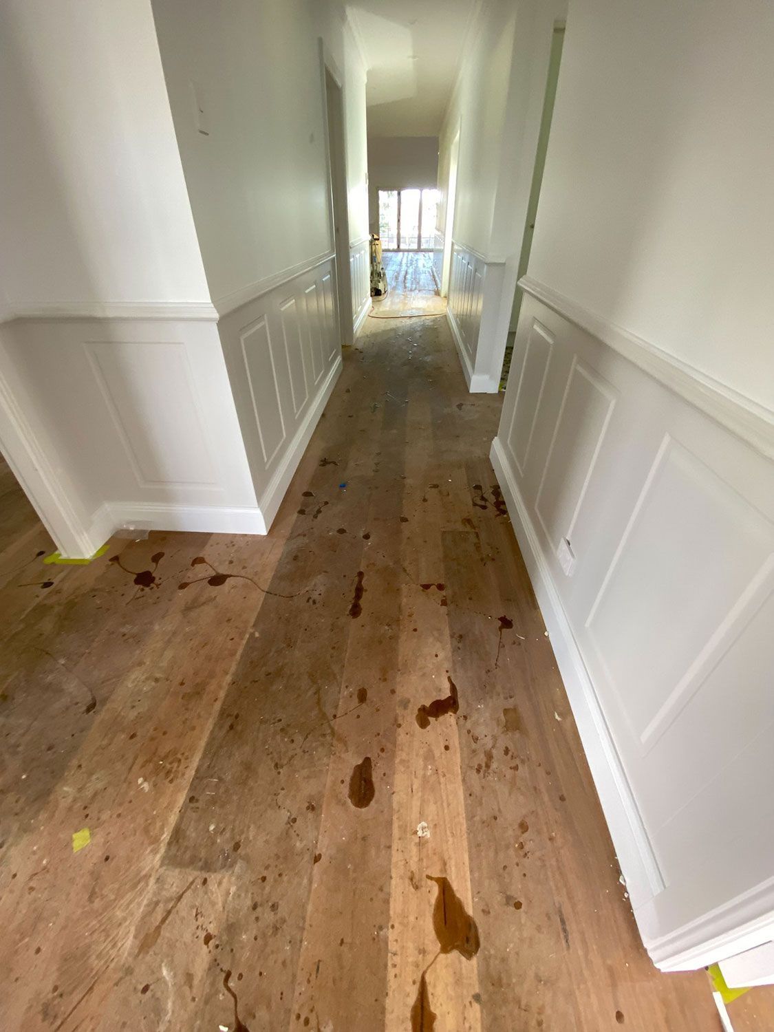A Long Hallway With Sanded Wooden Floors And White Walls — Brett Hall Floorsanding in Kempsey, NSW