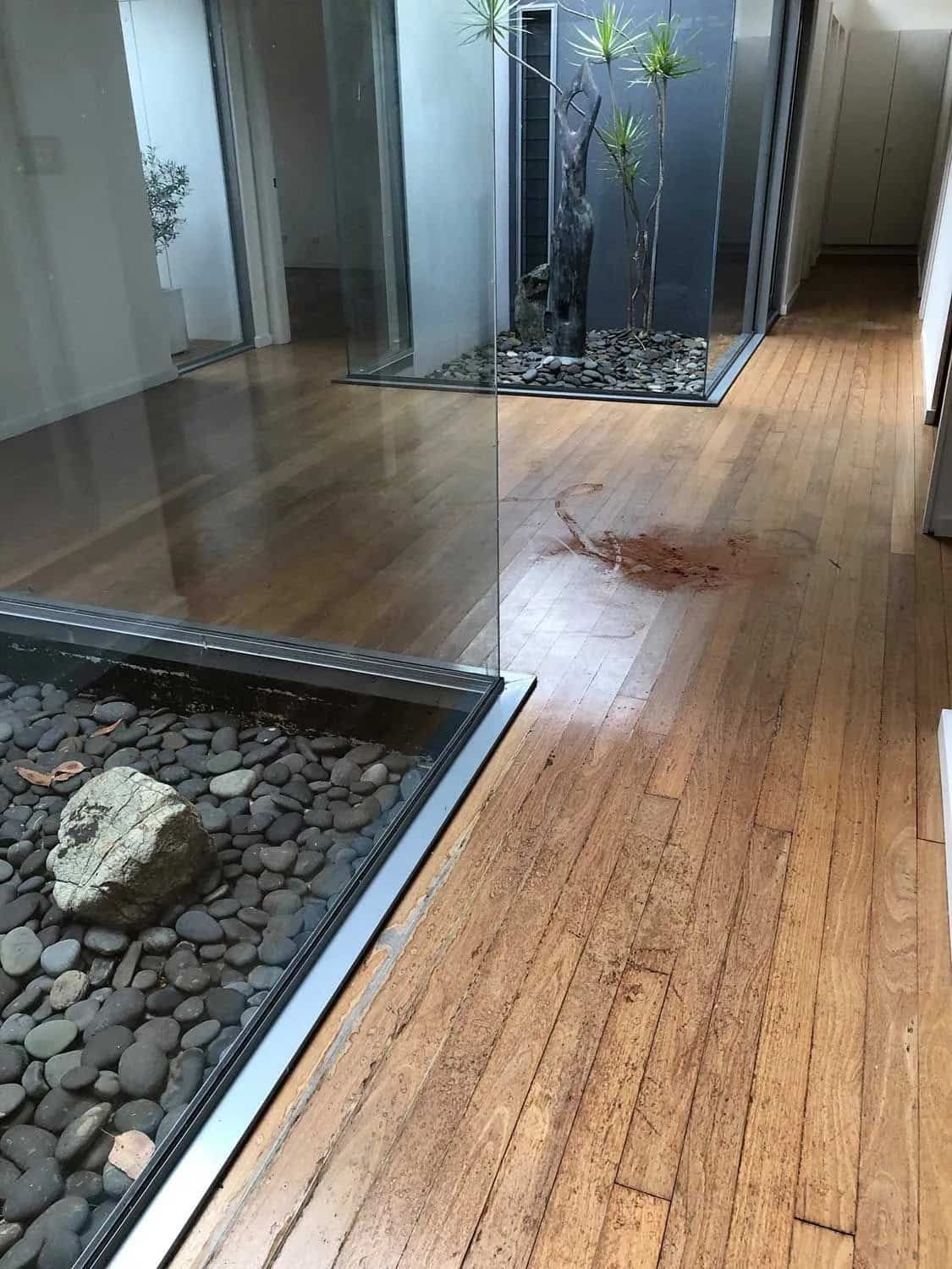 A Sanded Wooden Floor With A Rock In The Middle Of It — Brett Hall Floorsanding in Taree, NSW