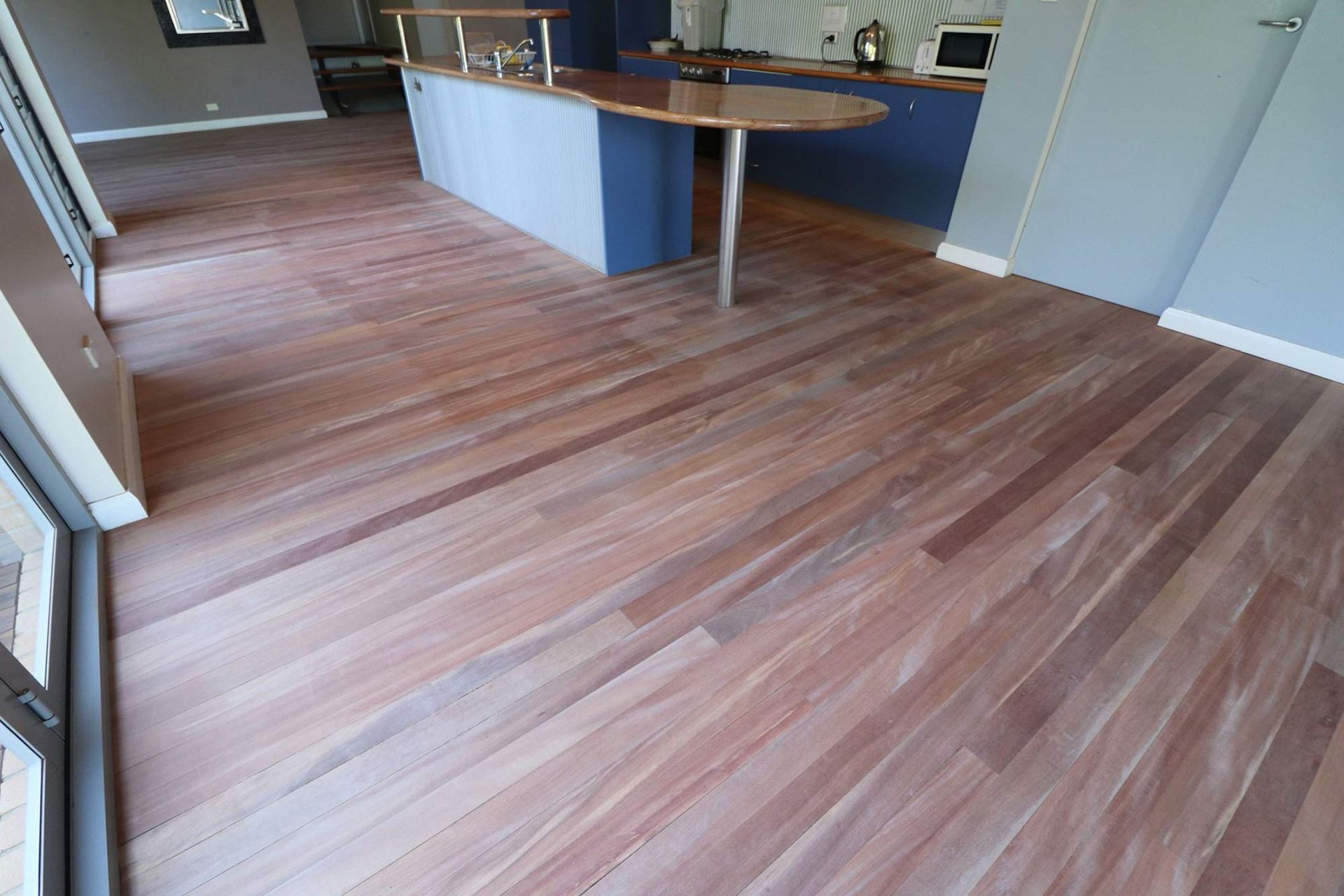 A Kitchen With A Wooden Floor And A Counter — Brett Hall Floorsanding in Wauchope, NSW
