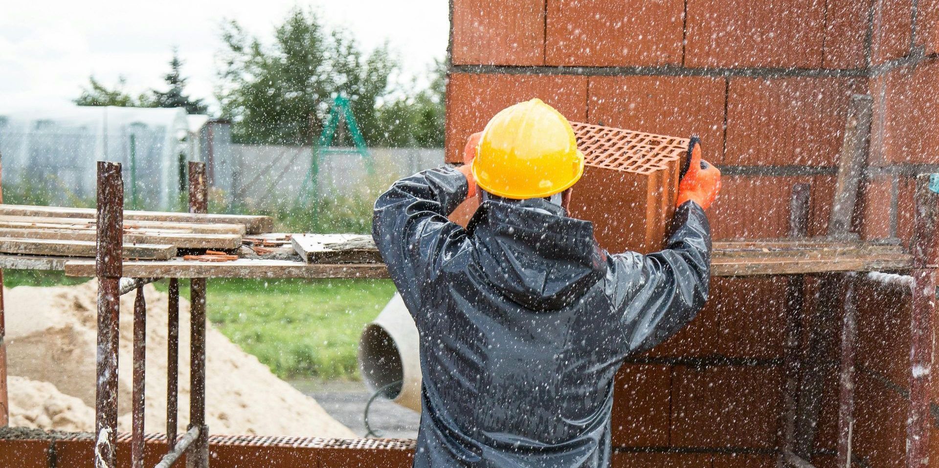 An MP Environmental worker places a brick cinderblock in a summer storm