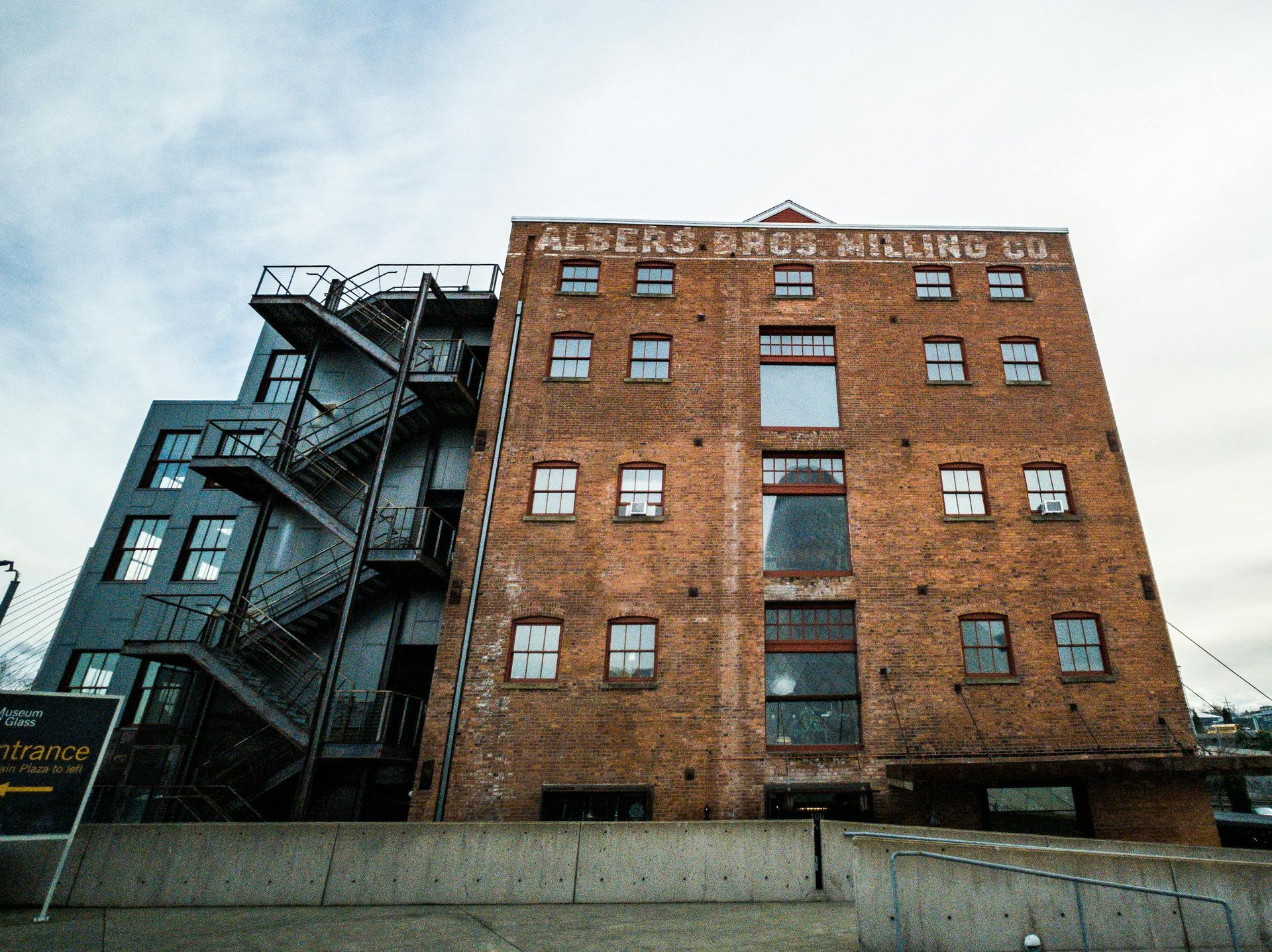 A large remediated brick building with a fire escape on the side of it.