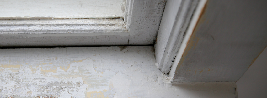 A close up of a window sill covered in chipped lead paint on an MP Environmental Services project