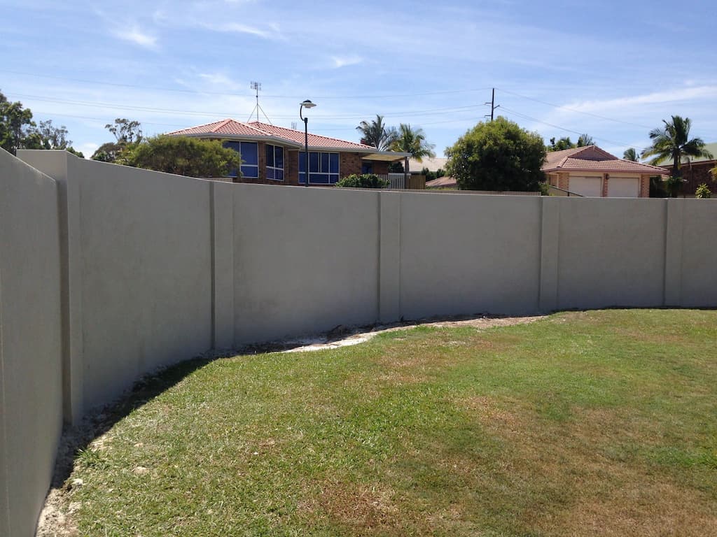 Rendered Walls Behind Grassland — Masonry Construction in Sunshine Coast, QLD