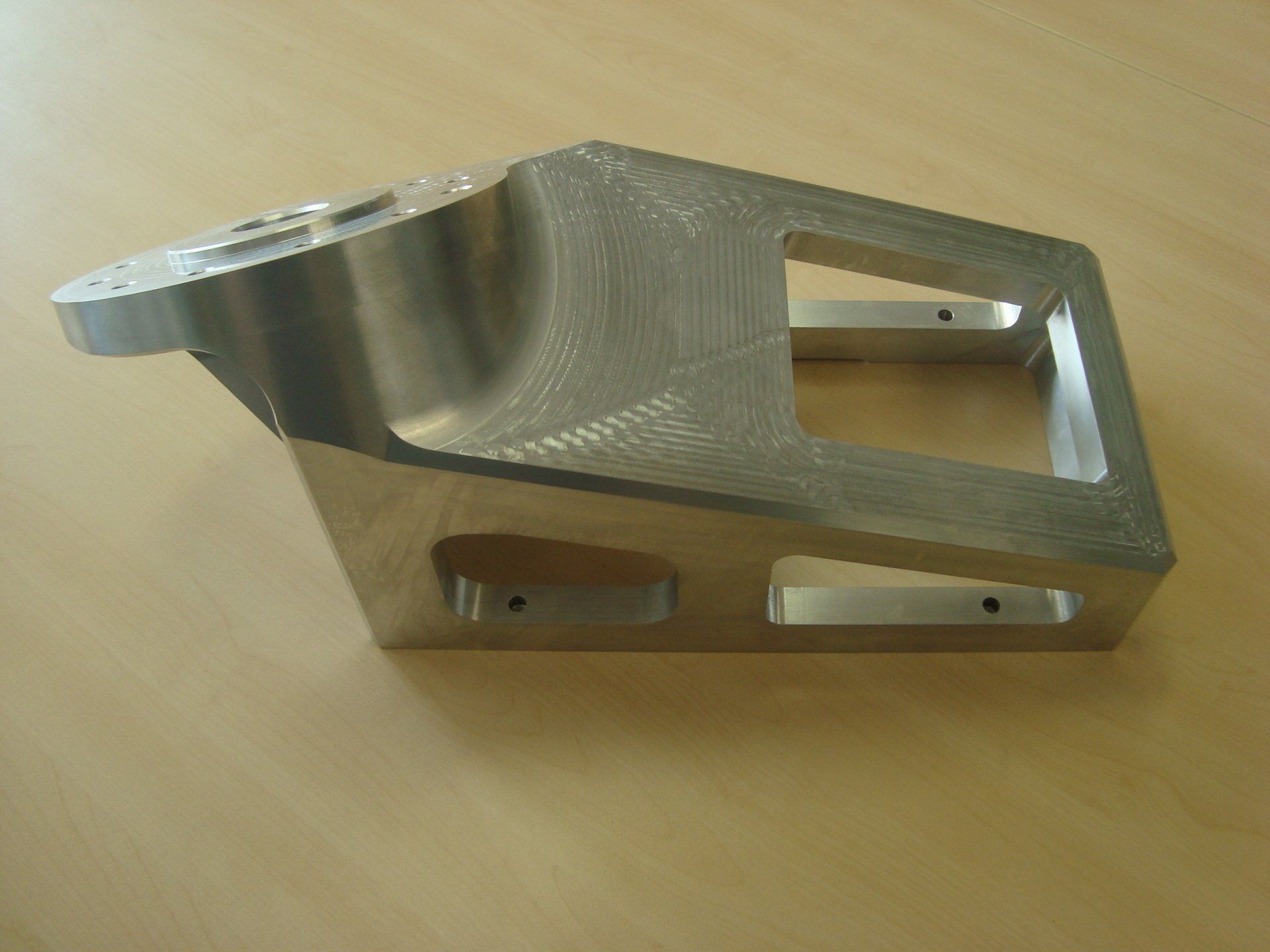 Er ligt een stuk metaal op een houten tafel.