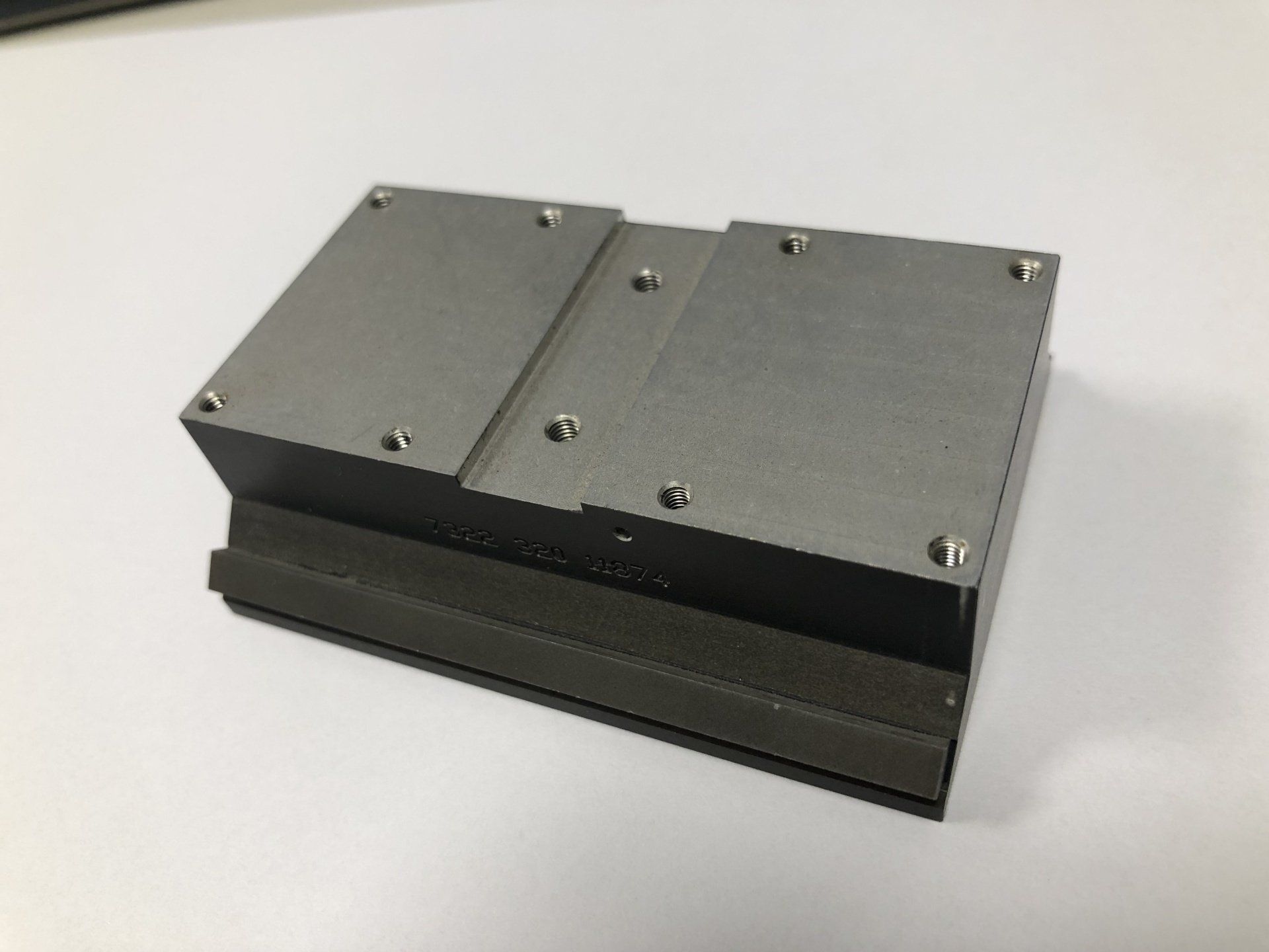 Een klein stukje metaal ligt op een wit oppervlak.