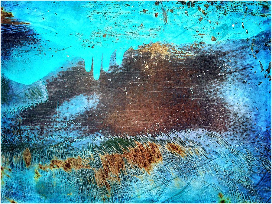 A close up of a rusty metal surface with a blue background