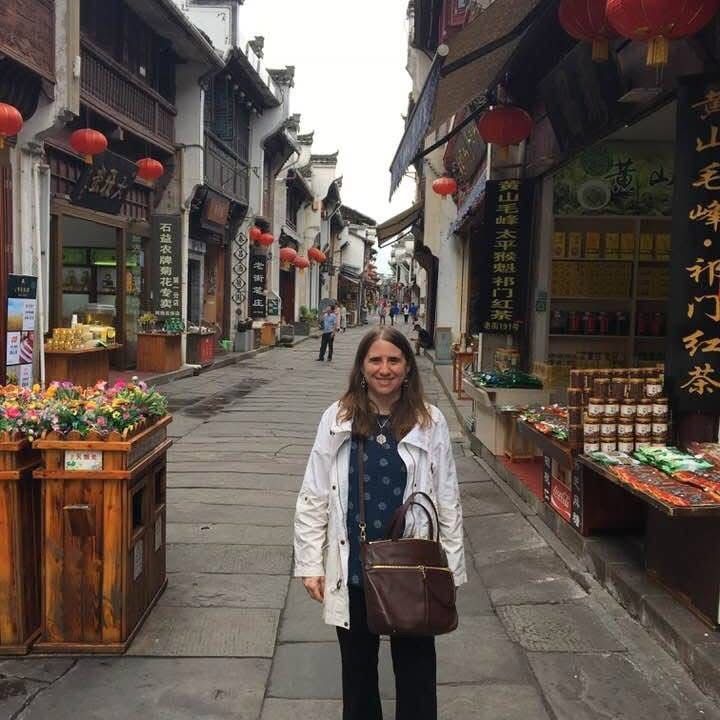 Dr. Carolina Franco is standing on a narrow street
