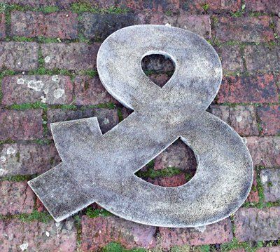 stone garden statue reverse ampersand letters