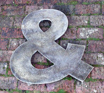 stone garden statue ampersand letters