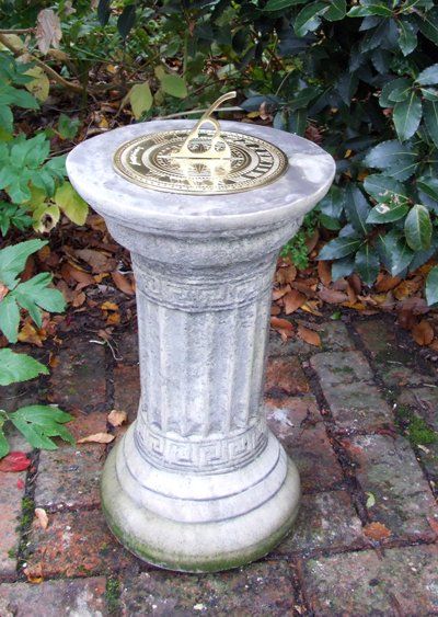 stone garden statue small brass sundial