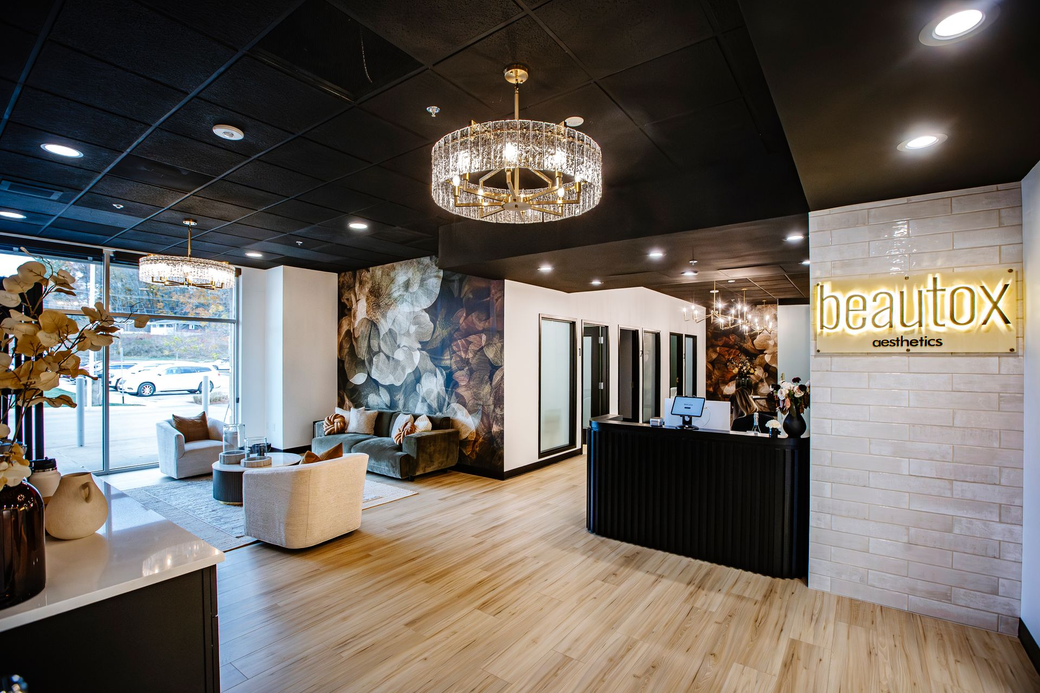 A living room with a couch , tables , and a mirror.