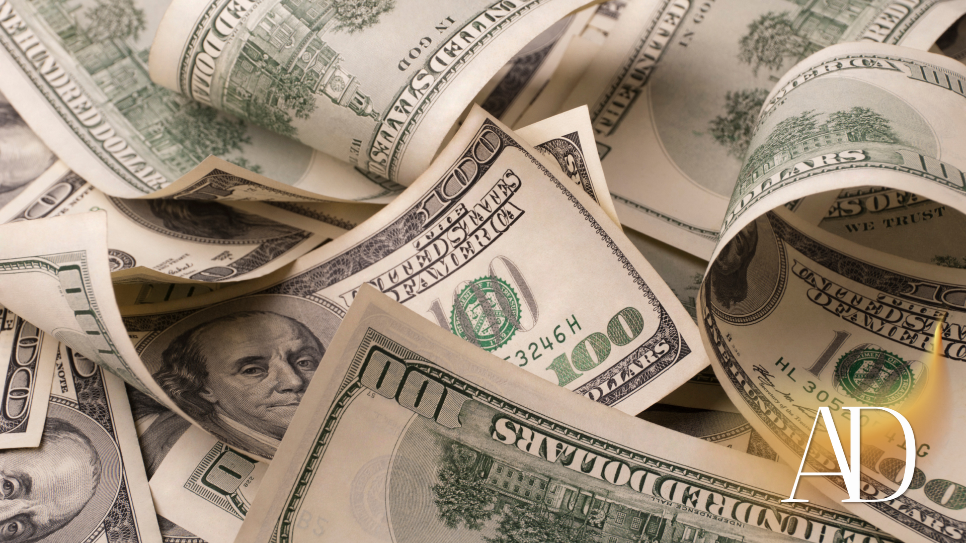 Heap of US $100 bills, some curled and crumpled, lit from the right side.