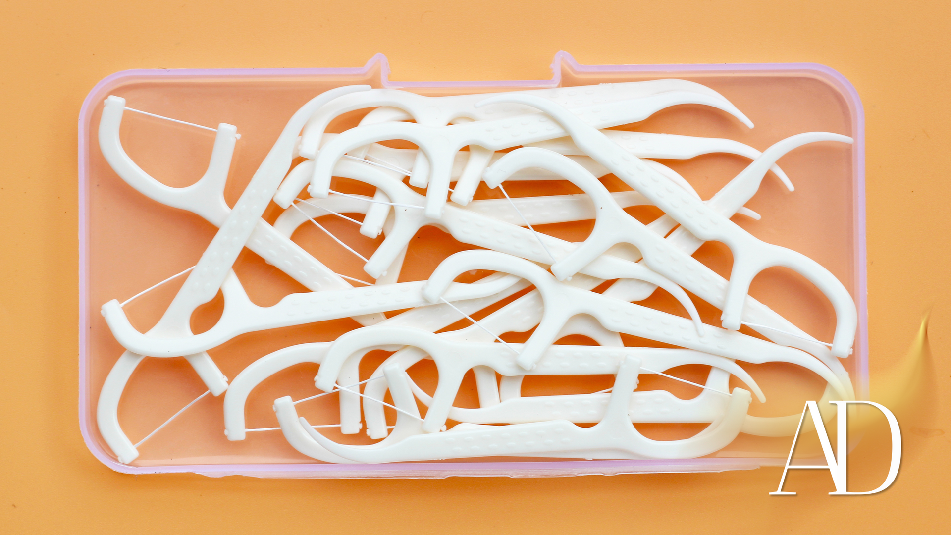 A box of dental floss is sitting on a table.