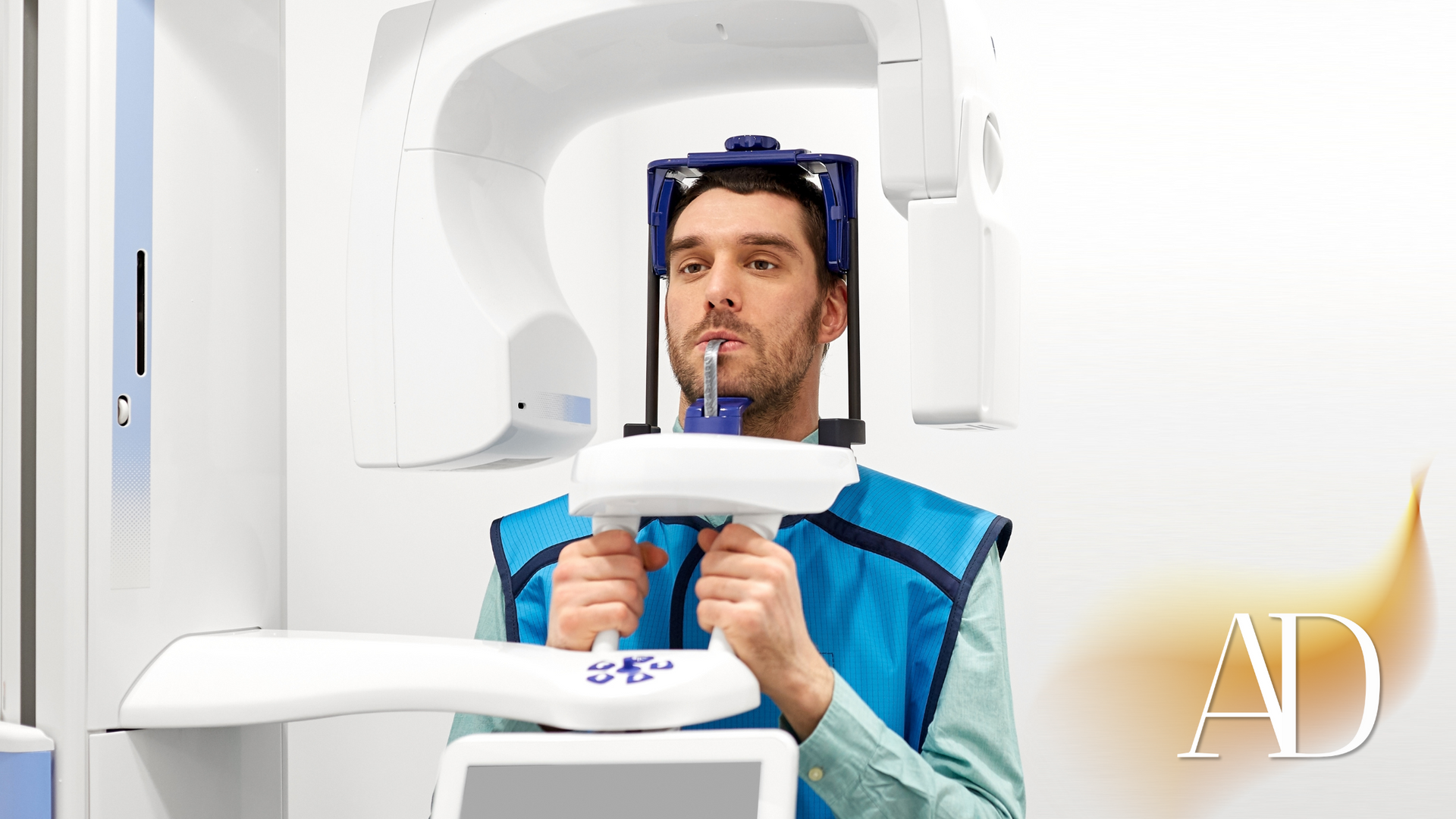 A man is getting an x-ray of his teeth in a dental office.