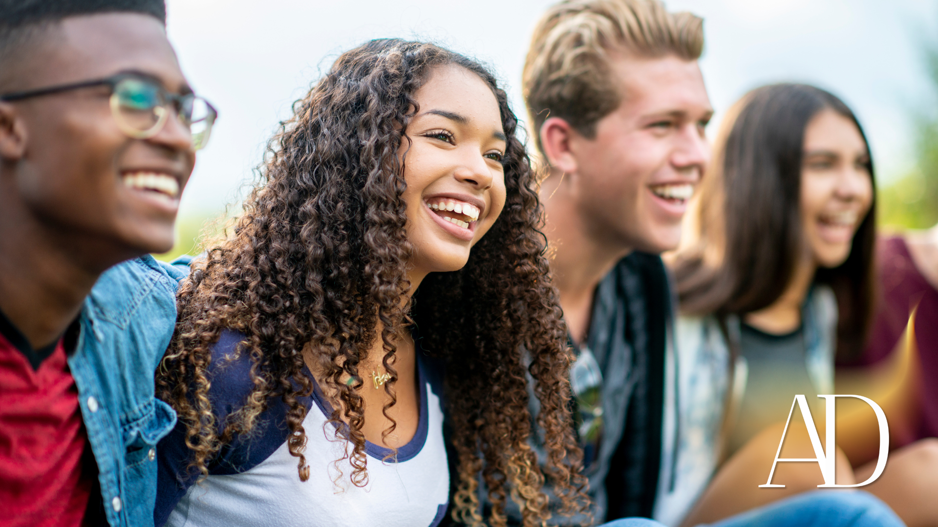 Group of friends smiling together outdoors.
