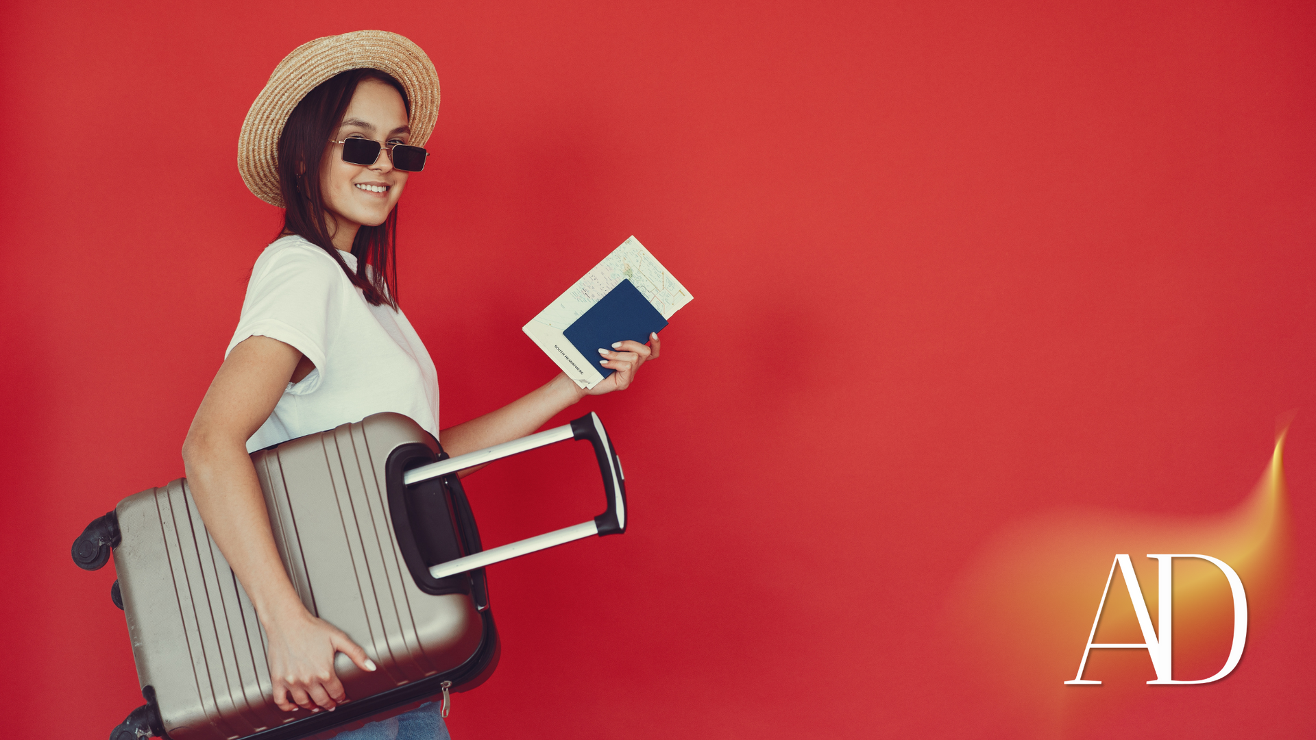 A woman is holding a suitcase and a passport.