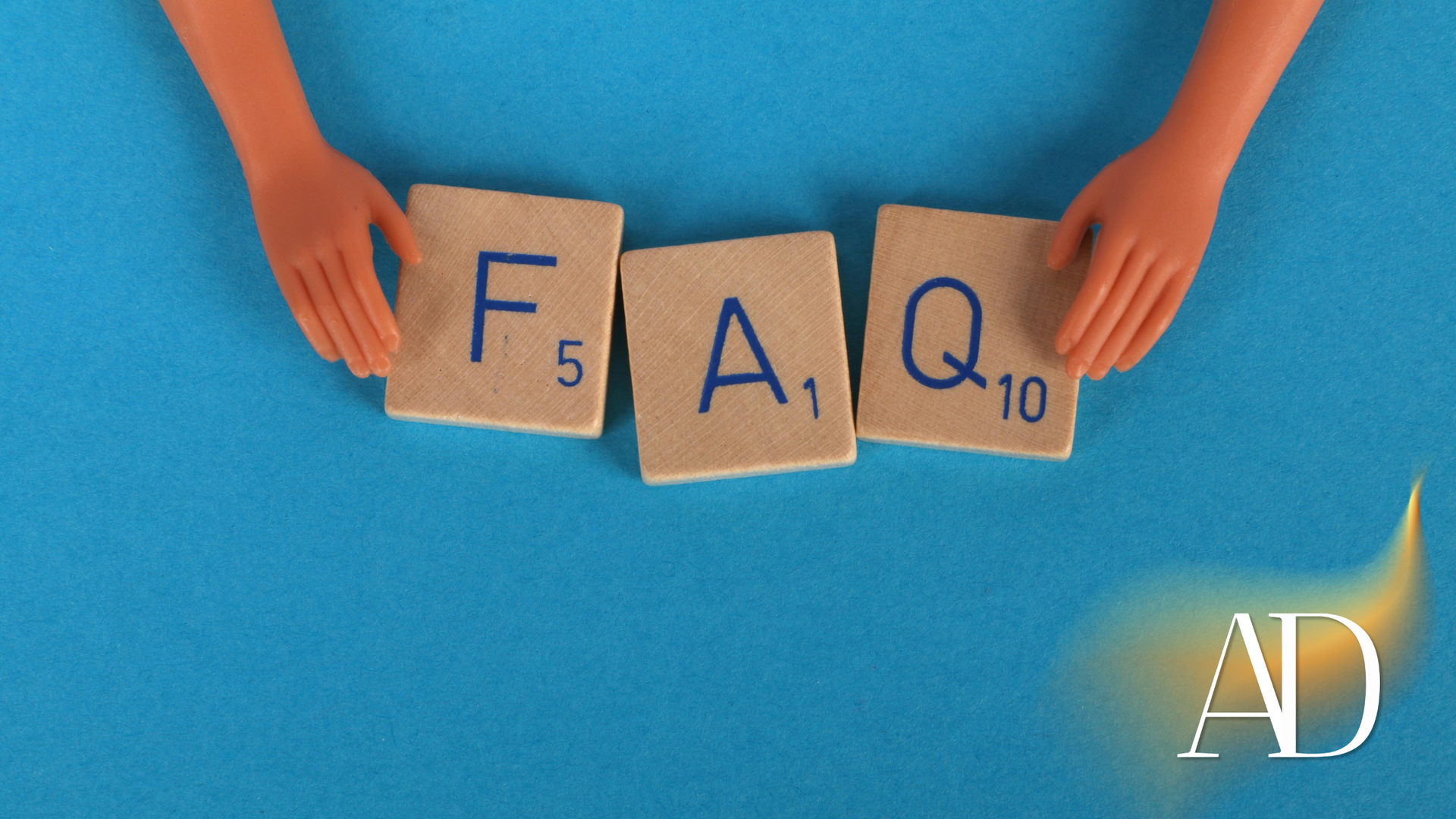 Hands holding Scrabble tiles spelling