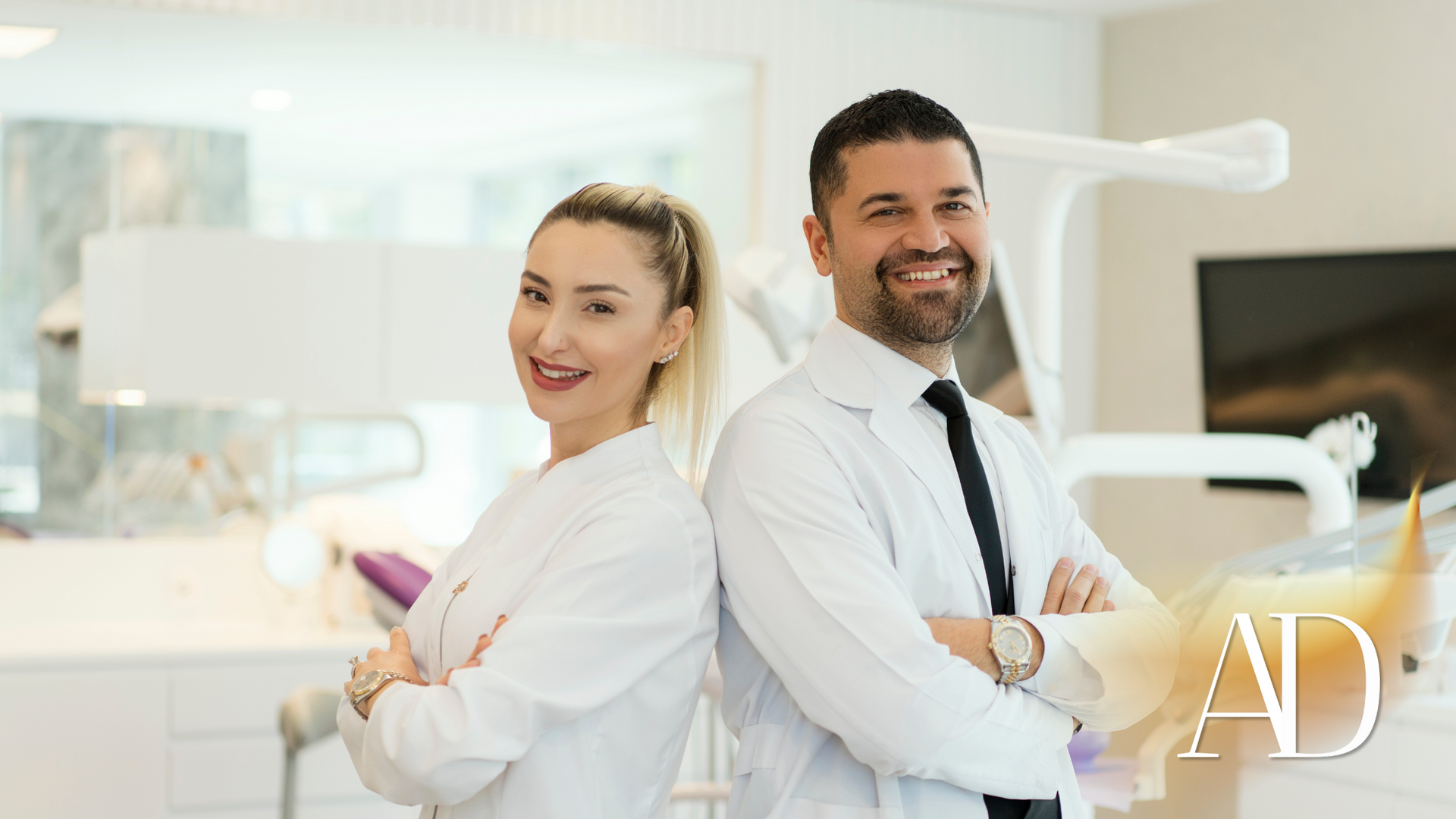 A man and a woman are standing back to back in a dental office.