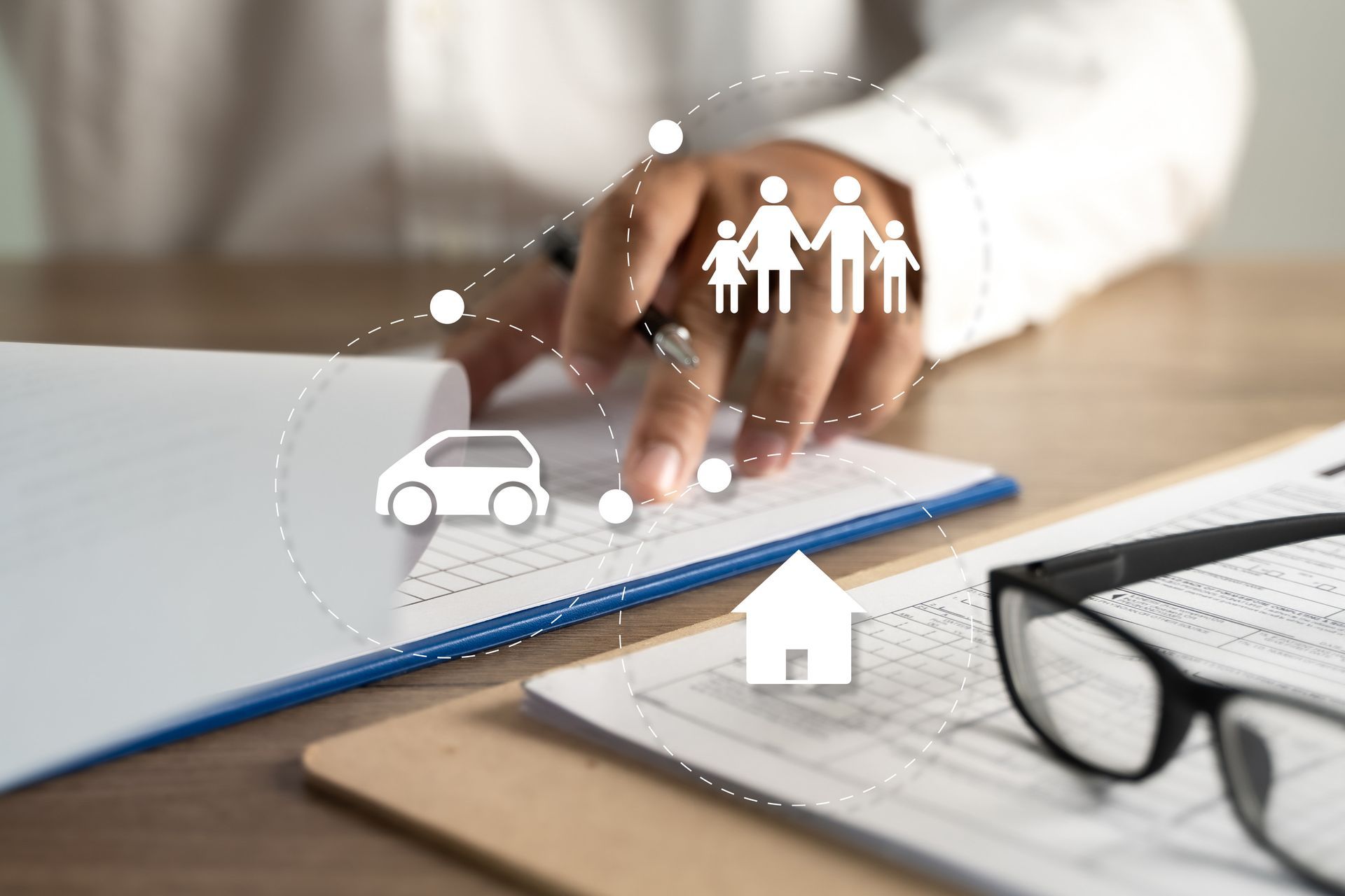 Person reviewing documents, icons of a car, house, and family.