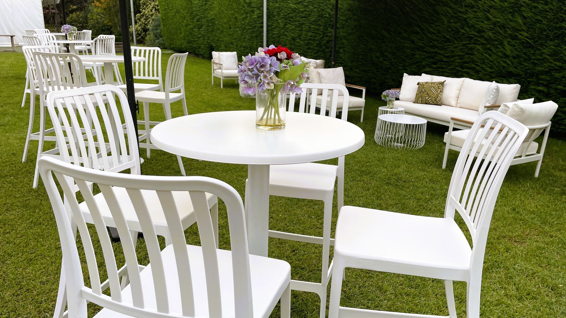 Four black bar stools are lined up in a kitchen