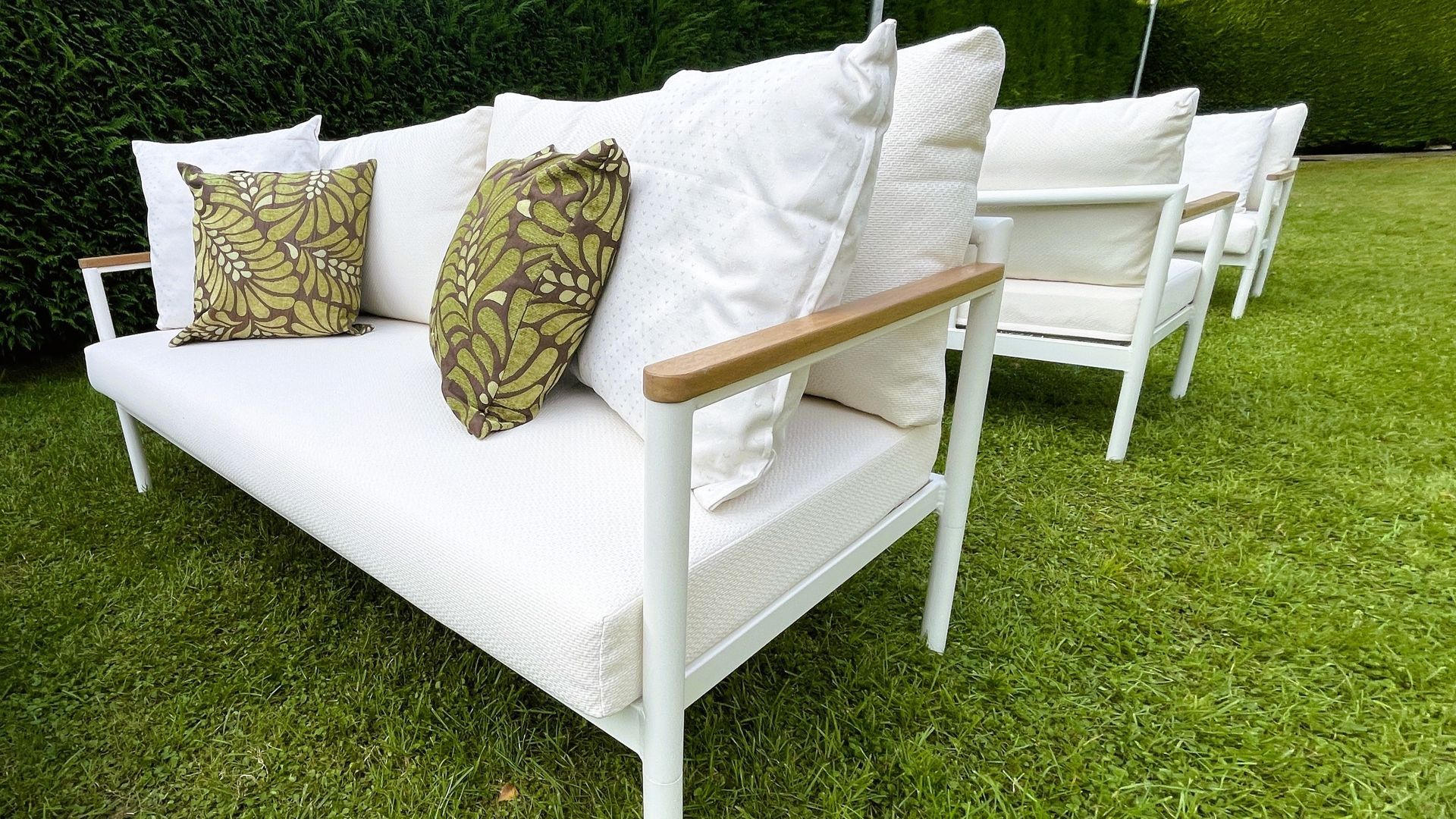 A patio set with a couch , chairs , and a coffee table.