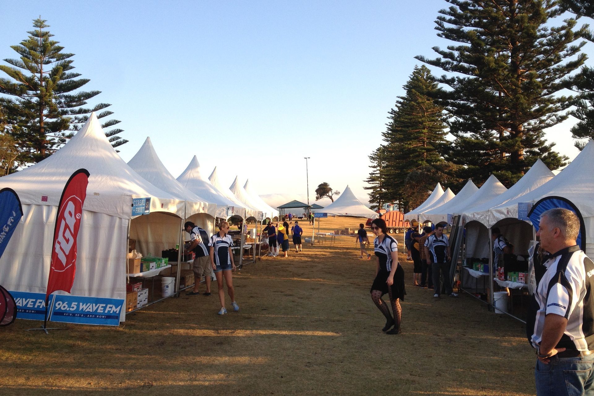 A man stands in front of a row of tents with one that says lg on it