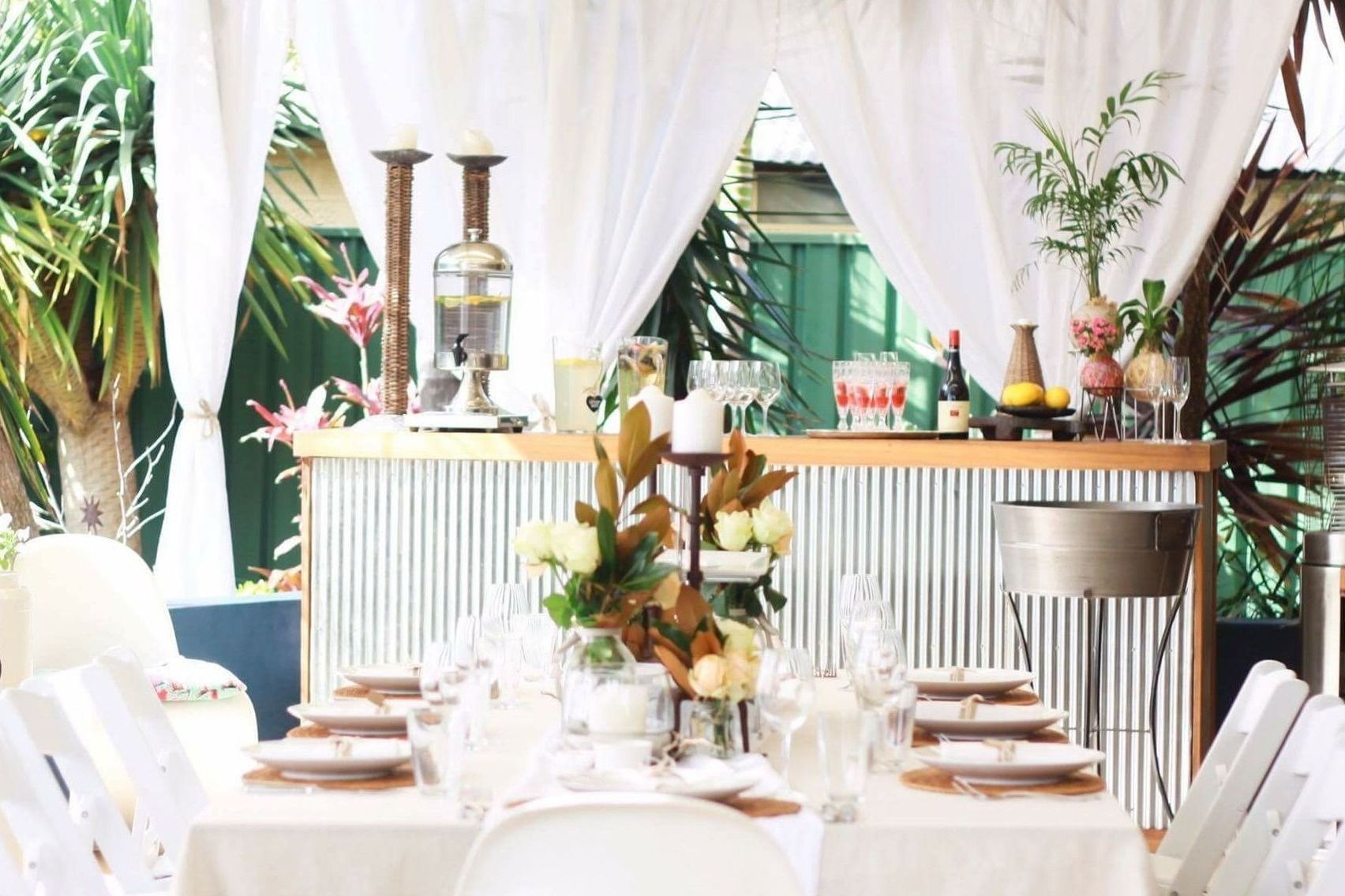 A table set for a party with a bar in the background.