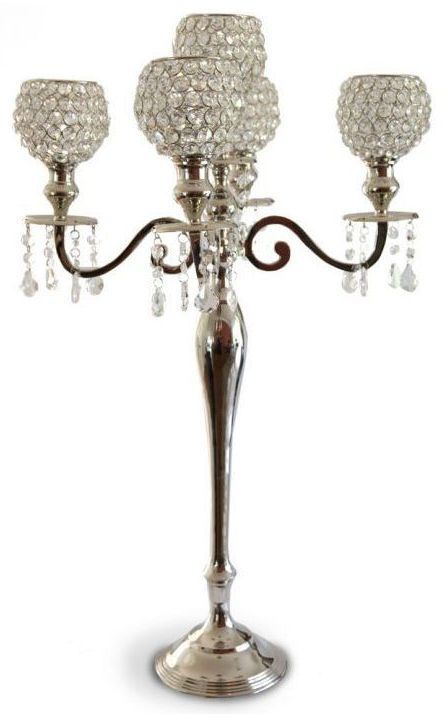 A silver candle holder with crystals on it